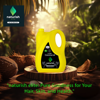 Naturish Elite 5L yellow coconut oil can on a wooden pedestal amid coconuts in a sunlit tropical forest, with brand logo and tagline.