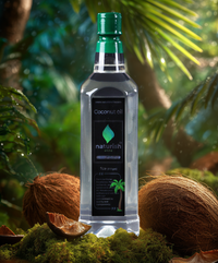 Naturish Elite 1‑litre coconut oil bottle standing on moss among coconuts in a lush, sunlit tropical forest setting.