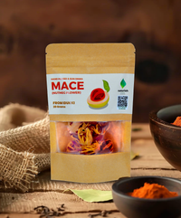 Naturish Elite mace (nutmeg flower) 20g kraft pouch from Idukki standing on rustic table with visible vibrant mace strands in window.
